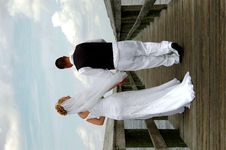 Bride And Groom On Boardwalk Royalty Free Stock Image