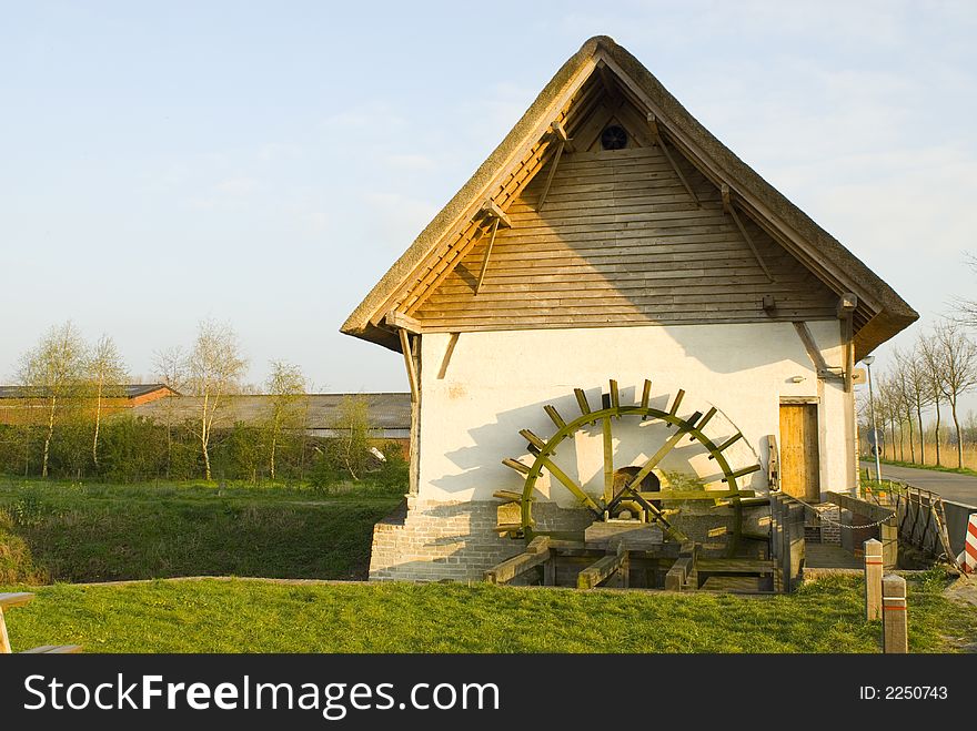 Old watermill in springtime landscape