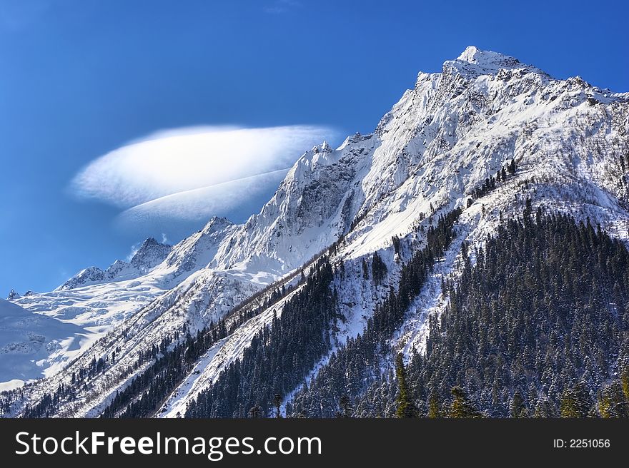 Strange cloud above the rock. Strange cloud above the rock