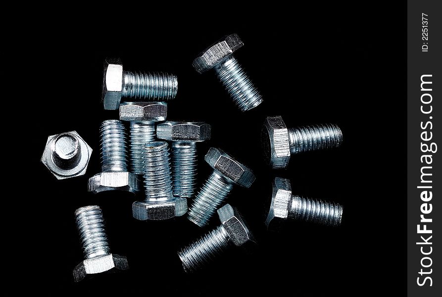 Close up of screws on black background