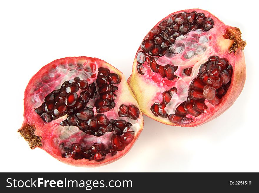 Two halfs of dark ruby pomegranate clouse-up. Two halfs of dark ruby pomegranate clouse-up