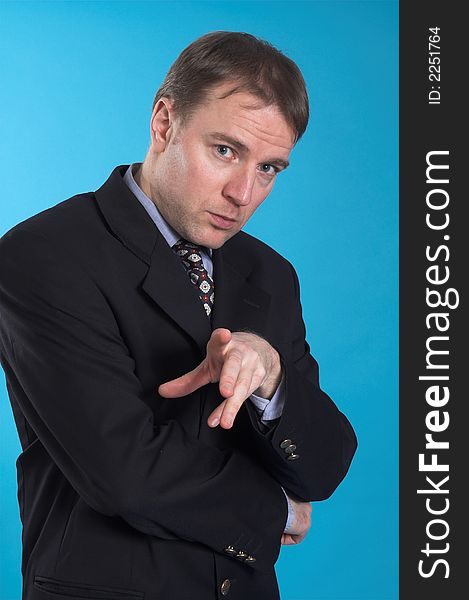 Man in business suit standing over blue background. Man in business suit standing over blue background