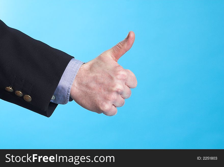 Businessman doing hand sign over blue background