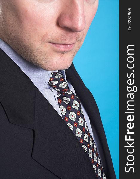 Man in business suit standing over blue background. Man in business suit standing over blue background