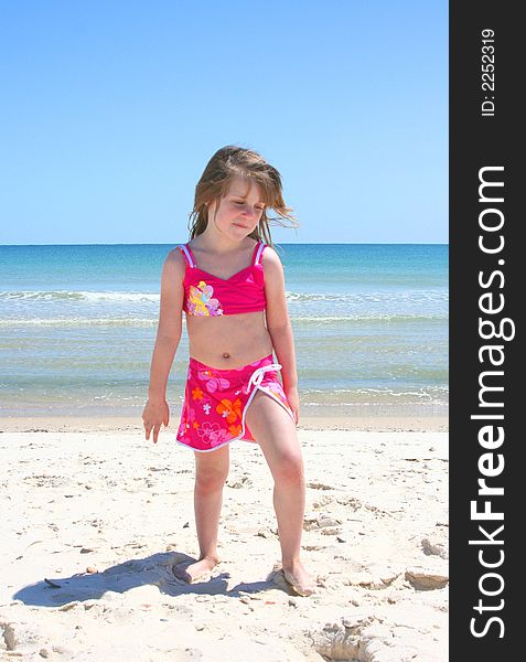 Girl playing in the sand at the beach. Girl playing in the sand at the beach