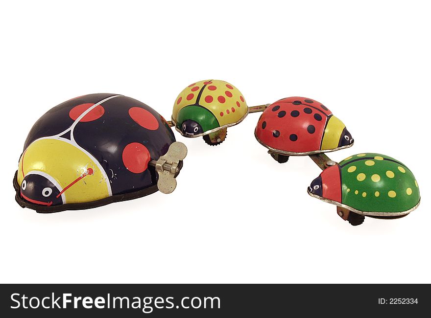 An antique tin toy lady bug with her family attached. An antique tin toy lady bug with her family attached