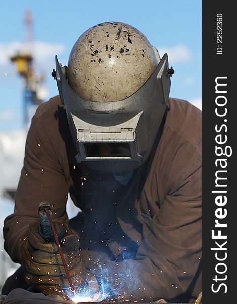 Worker welding steel on dayshift. Worker welding steel on dayshift