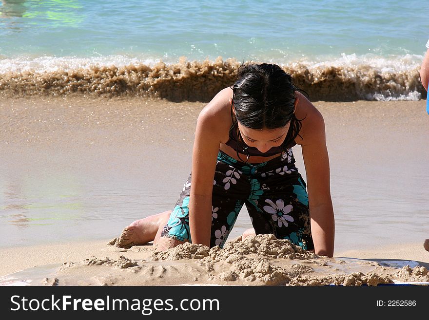 Girl playing with sand on beach. Girl playing with sand on beach