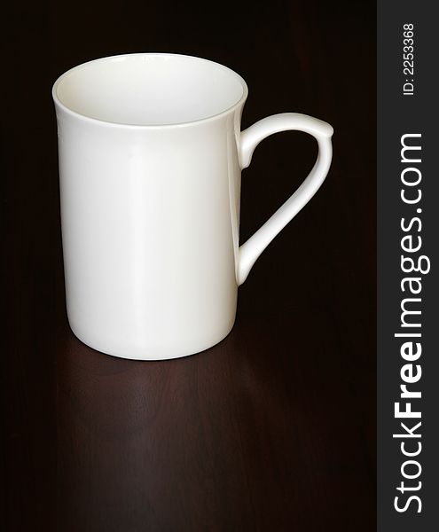 White Empty Coffee Cup On A Dark Wooden Table, Reflection. White Empty Coffee Cup On A Dark Wooden Table, Reflection