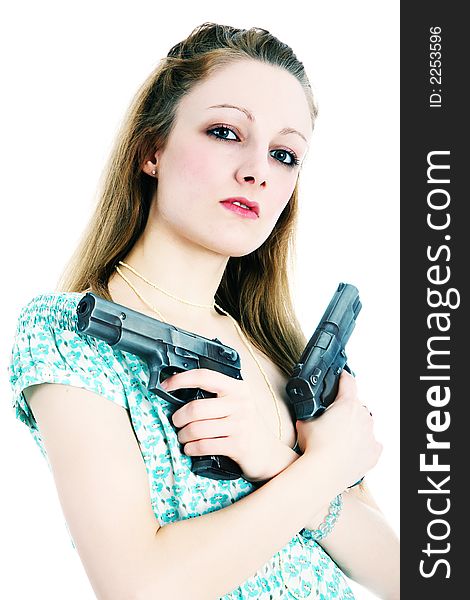 Young woman holding guns across her chest (crossed processed). Young woman holding guns across her chest (crossed processed)