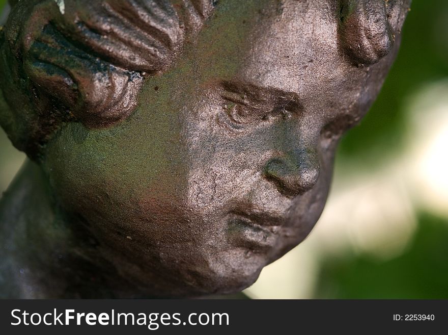 Details of the a bronze statue of a child. Details of the a bronze statue of a child