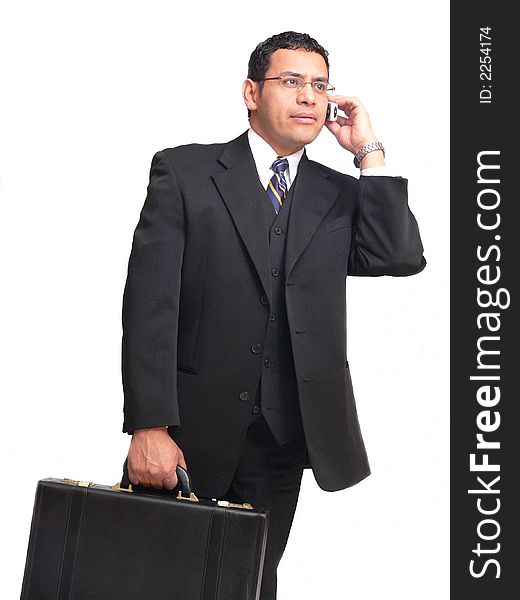 An businessman on the run is talking on his cell phone and carrying					
a briefcase.