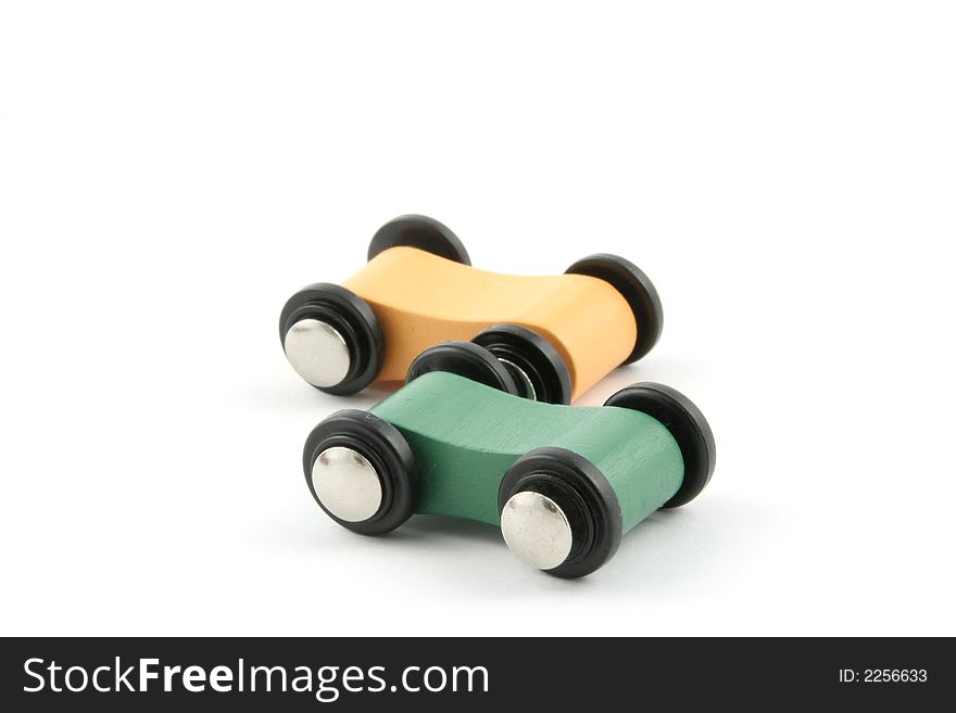 Colourfull toy wooden cars on a white background