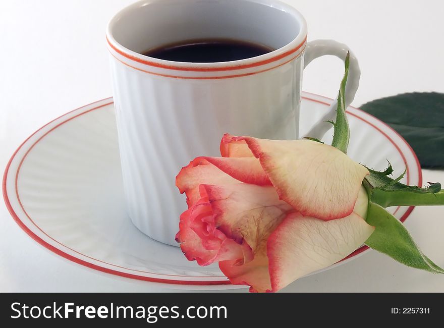 A relaxing moment with  coffee and a rose on a white background. A relaxing moment with  coffee and a rose on a white background