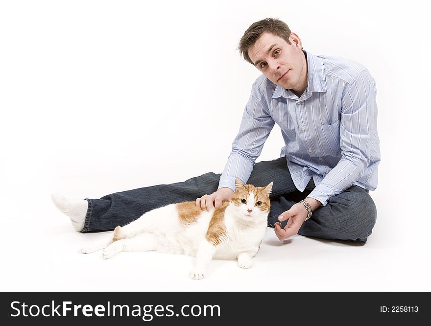 Young man spends time playing with his pet cat. Young man spends time playing with his pet cat