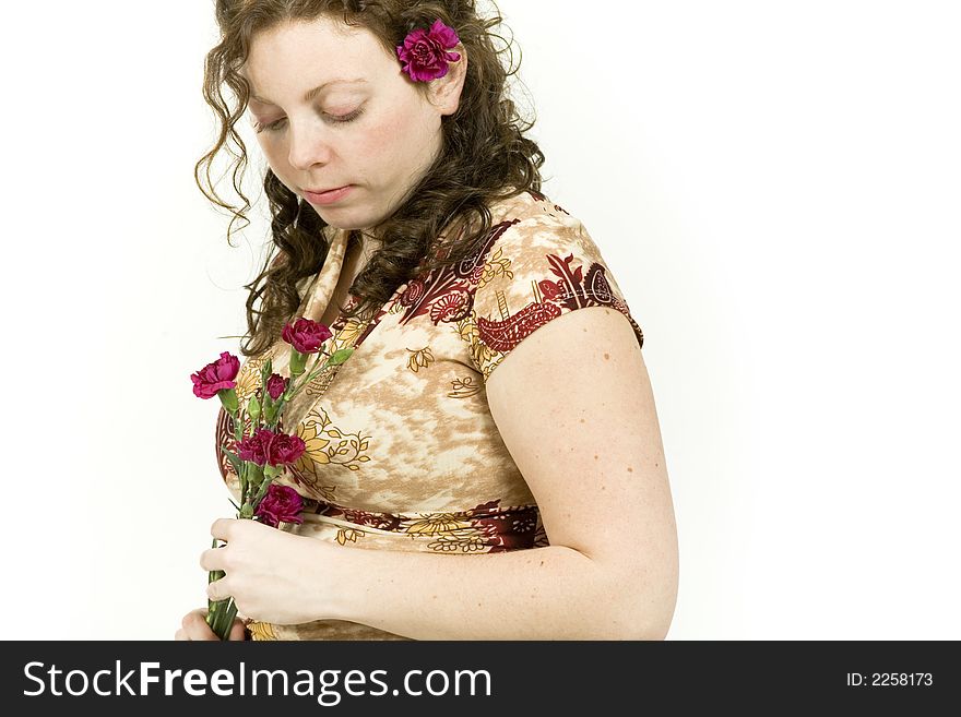 Beautiful young woman poses with red flowers