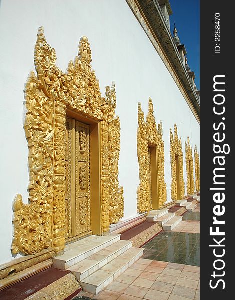 Temple doors with golden grand carving decoration. Temple doors with golden grand carving decoration