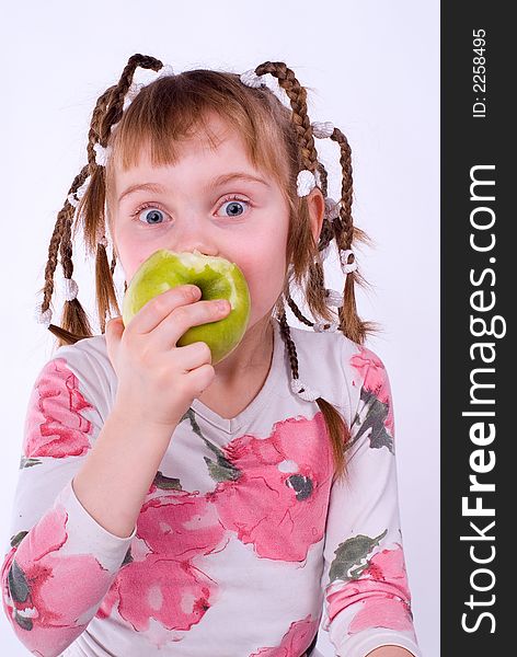 The girl in a dress with an apple on a white background. The girl in a dress with an apple on a white background