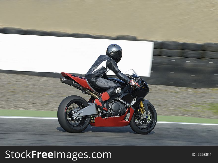 Motor biker an a race track. Motor biker an a race track