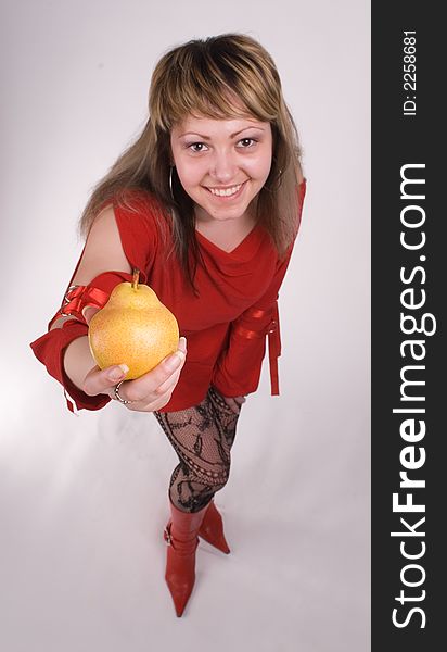 The girl in a red dress with a pear on a white background. The girl in a red dress with a pear on a white background