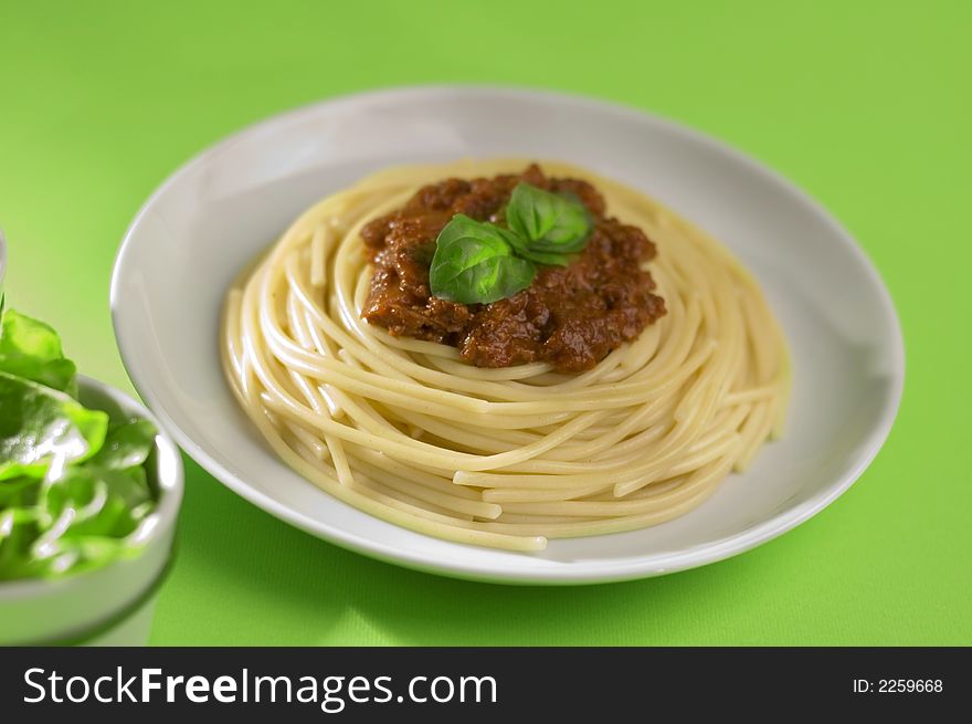 Spaghetti bolognese from Italy on the green background