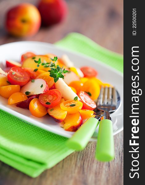 Peaches, nectarines, tomatoes and thyme salad, selective focus