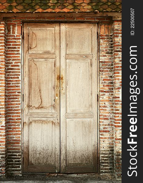 Old wooden doors and old brick wall