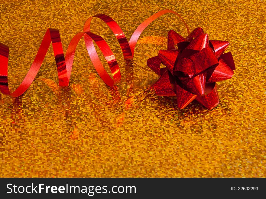 Red Bow with red ribbon on a gold background. Red Bow with red ribbon on a gold background