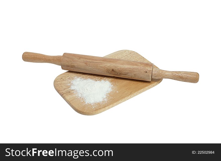 Wooden rolling pin and flour lying on cutting board. Isolated with clipping path