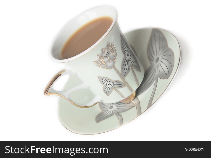 Cup of coffee with milk or cream and saucer