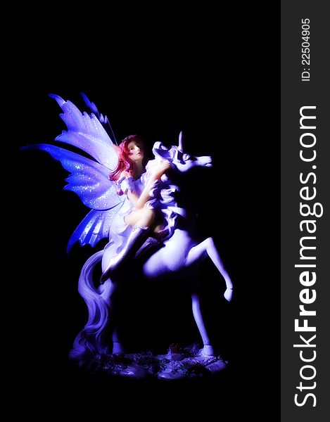 Magic fairy figure riding unicorn