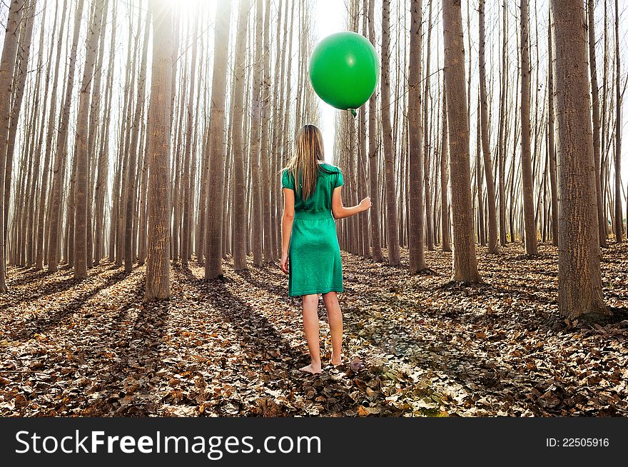 Beautiful Blonde Girl Standing In The Forest