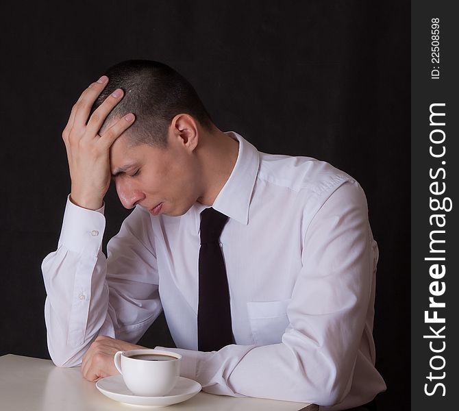 Portrait of businessman drinking coffee on black. Portrait of businessman drinking coffee on black