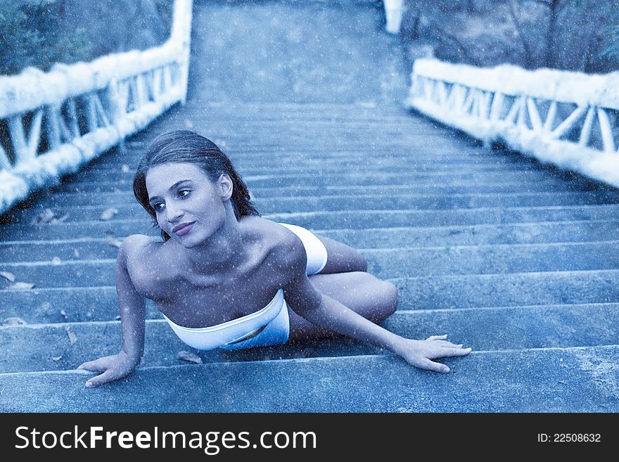 Fabulous woman lying on icy stairs