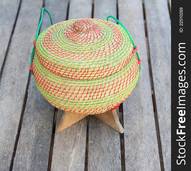 Rice Box Made From Bamboo And Nylon On Old Wooden.