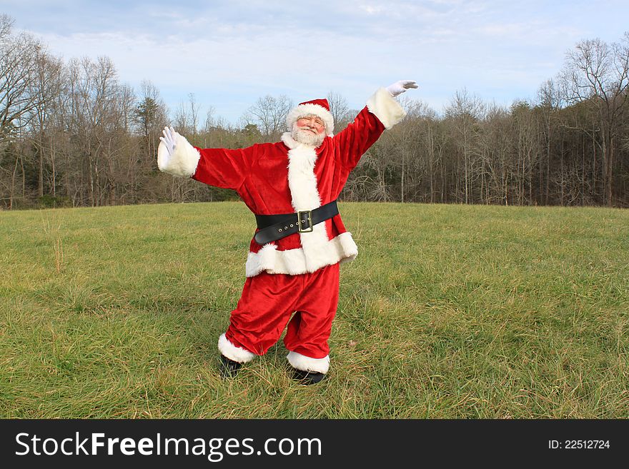Happy Santa Claus dancing in an open field. Happy Santa Claus dancing in an open field.