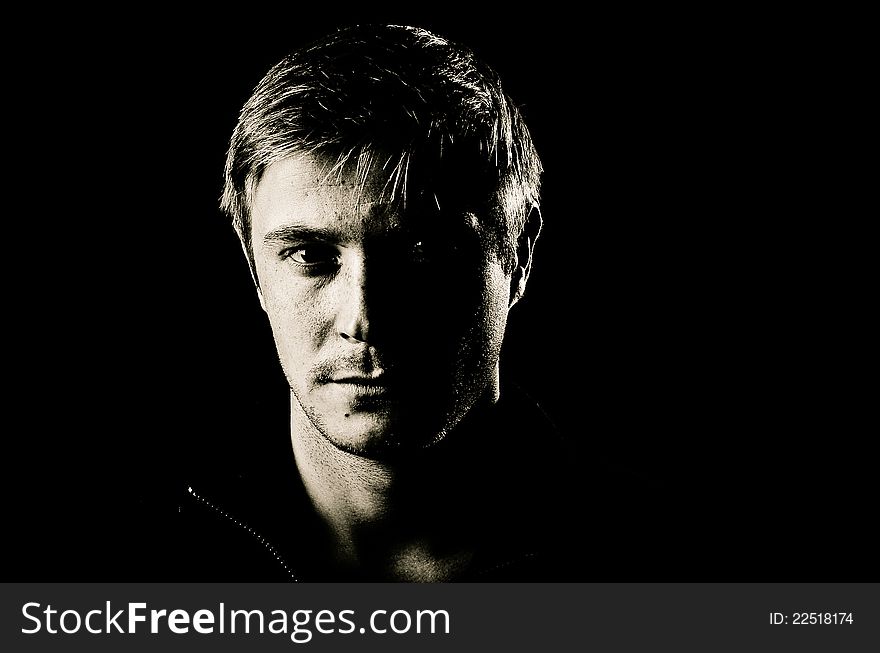 Black and white portrait of man on black background. Black and white portrait of man on black background