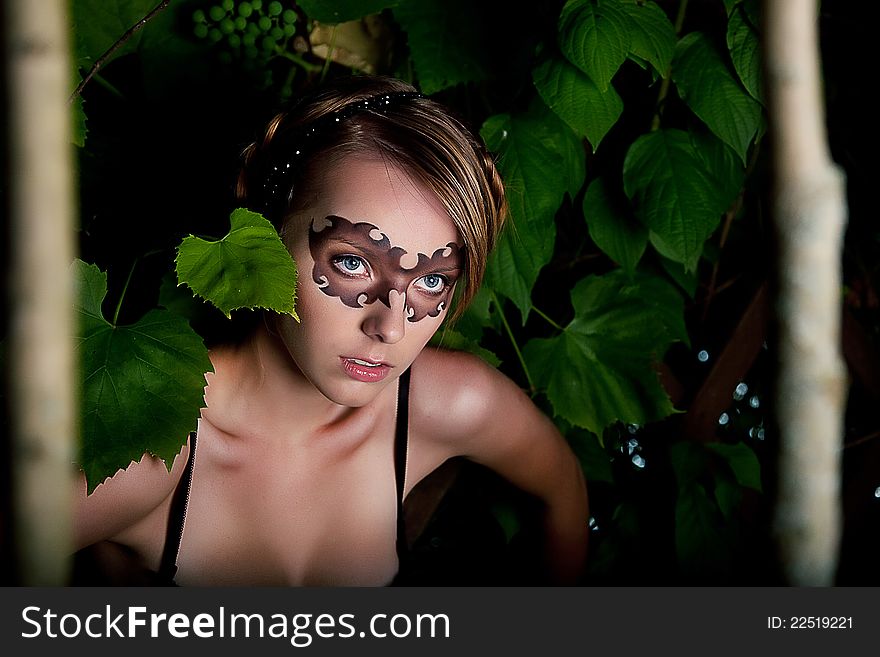 Fancy dress party - young girl in carnival mask among trunks of trees. Series of photos outdoor. Fancy dress party - young girl in carnival mask among trunks of trees. Series of photos outdoor