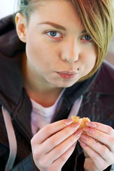Portrait Of Girl With Eats Burger On The Terrace Royalty Free Stock Image