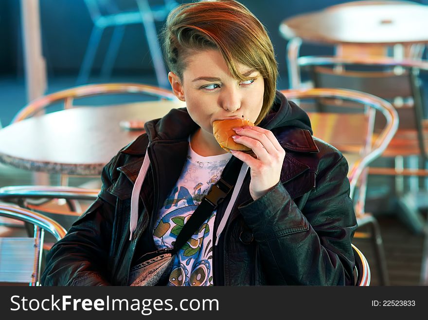 Portrait Of Girl With Eats Burger On The Terrace