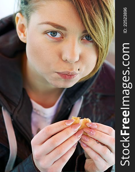 Portrait Of Girl With Eats Burger On The Terrace