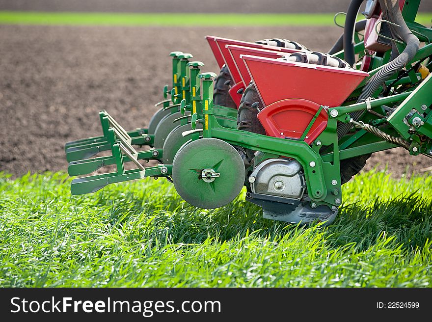 Tractor and seeder planting crops on a field