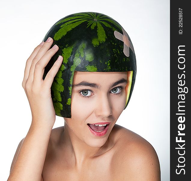 Laughing young pretty girl in helmet - fresh watermelon - series of photos. Laughing young pretty girl in helmet - fresh watermelon - series of photos