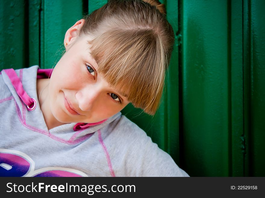 Smilingteenage girl on a green background