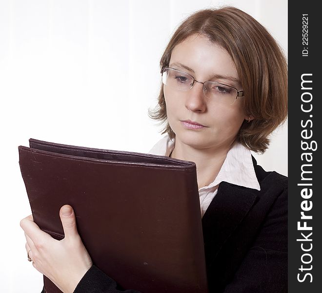 A businesswoman with glasses and clipboard