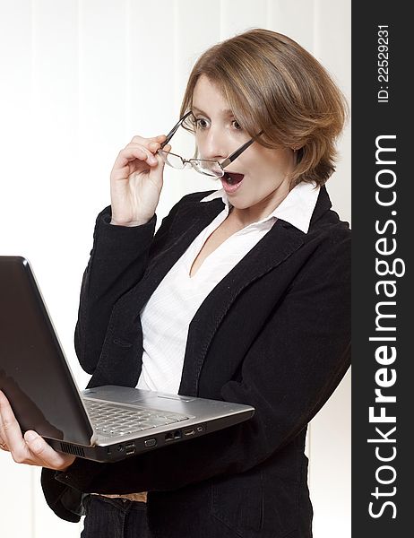 Surprised businesswoman looking at laptop