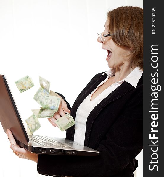 Businesswoman excited of money flying out of computer