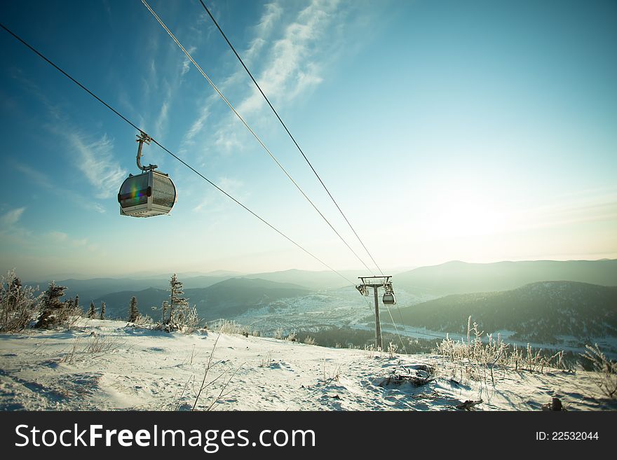 The mountain-skiing lift, blue sky and mountains. The mountain-skiing lift, blue sky and mountains