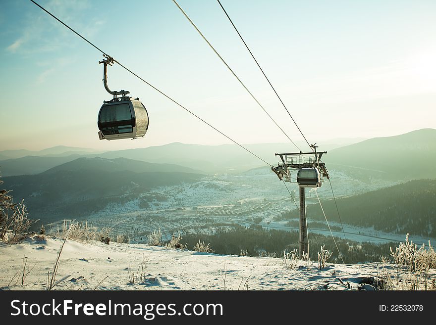 The mountain-skiing lift, blue sky and mountains. The mountain-skiing lift, blue sky and mountains