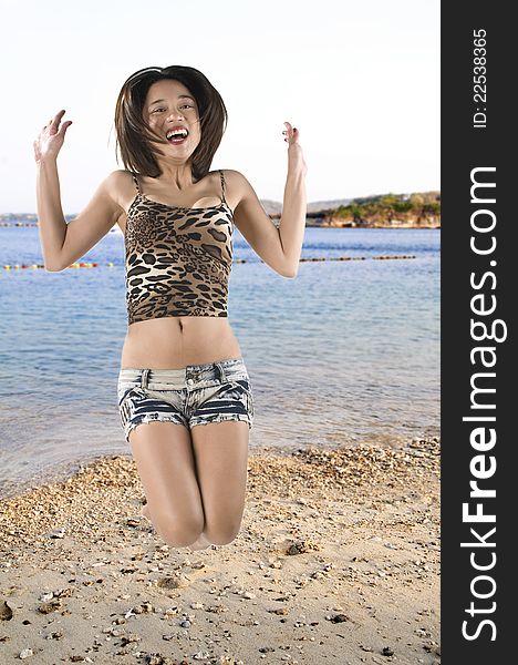 Picture of a girl jumping for joy in the beach. Picture of a girl jumping for joy in the beach